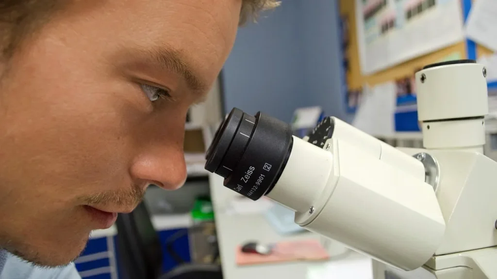 Scientist reviewing data on a monitor in a lab