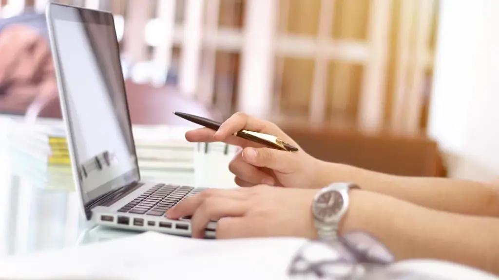 A person working on a laptop in an office