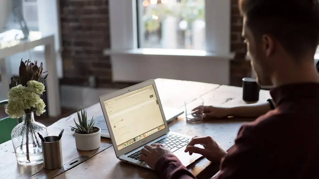 security researcher reviewing code on a laptop in a bright office