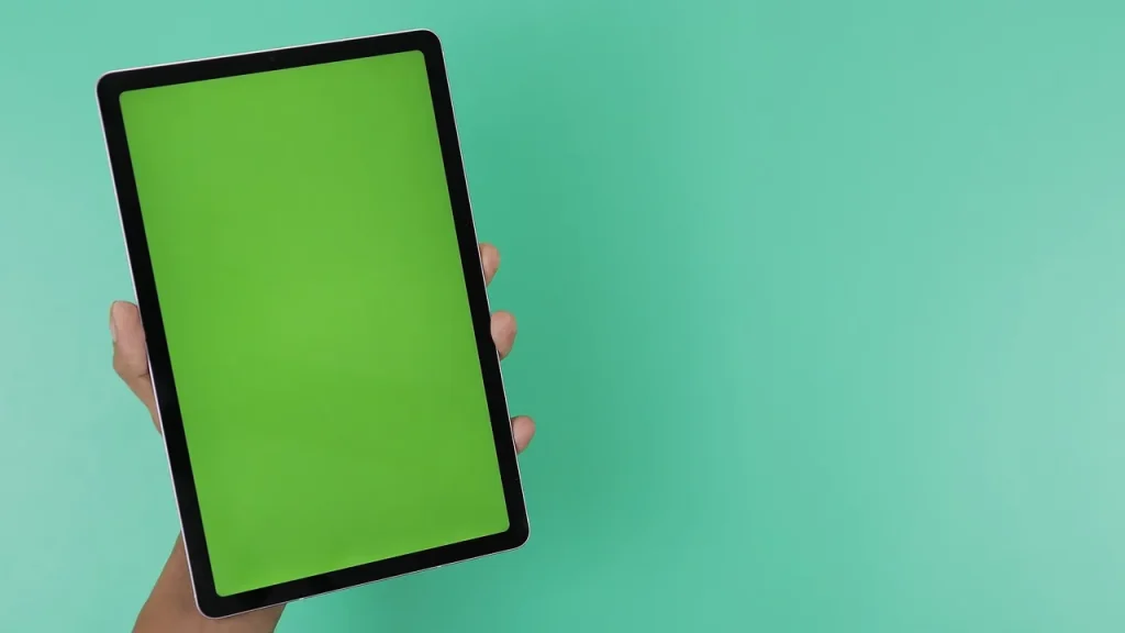 Hands holding an 11-inch tablet showing a home screen