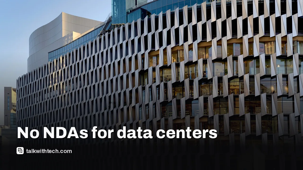 A large data-center exterior building viewed from the parking lot.
