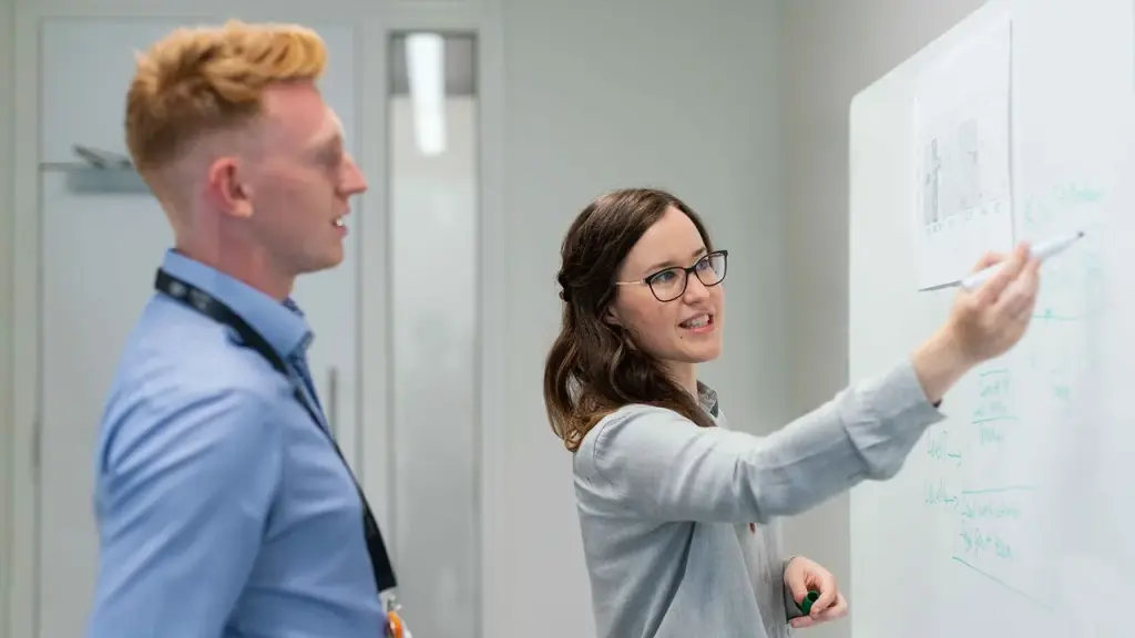 Engineers collaborate at a whiteboard