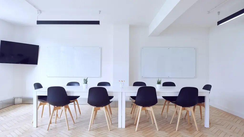 Conference room with screens showing AI chat tool