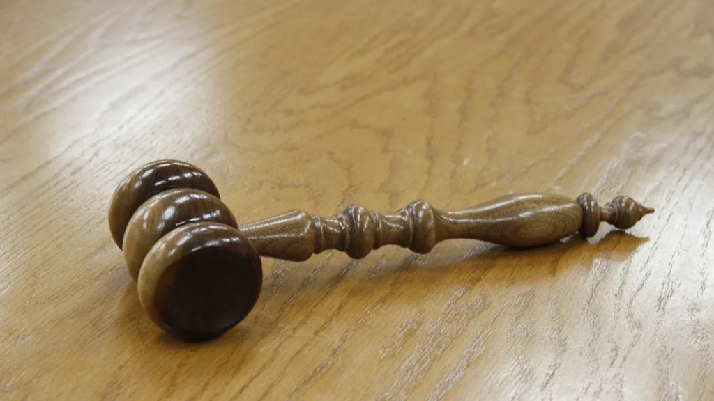 Gavel and patent documents on a desk in a courtroom-style setting