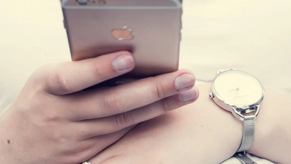 Person checking health stats on an iPhone at home