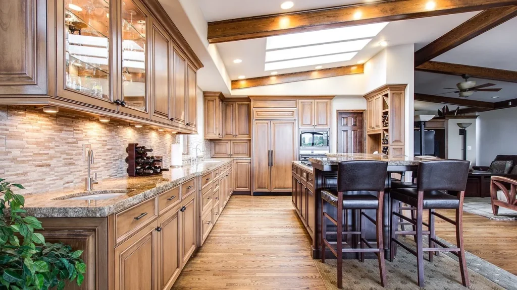 A small smart speaker sits on a kitchen counter in a modern kitchen