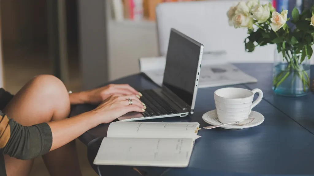 A laptop sitting on a desk in a bright workspace