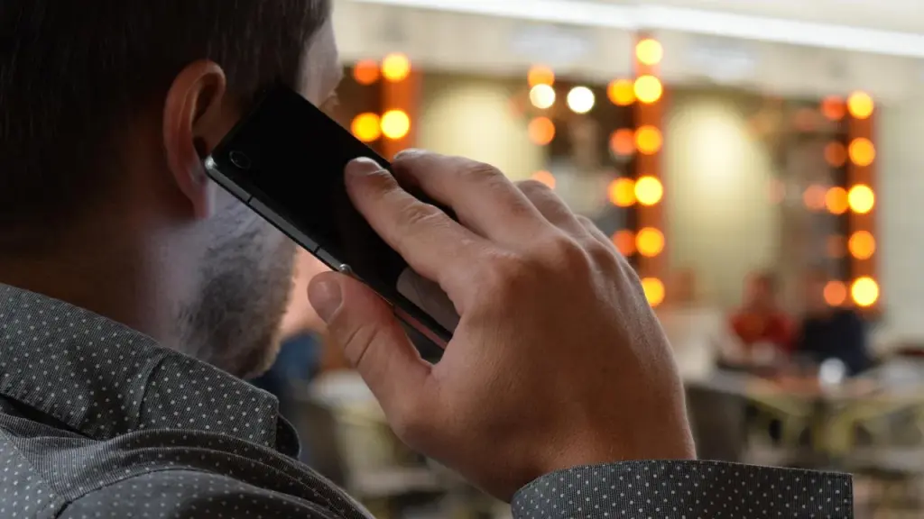 Close-up of a hand holding a smartphone during a call.