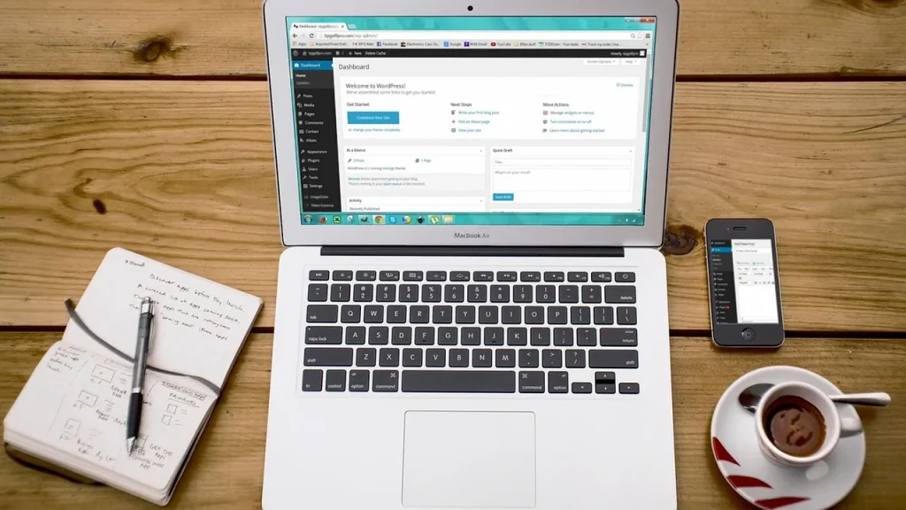 A smartphone next to a laptop with a browser window open