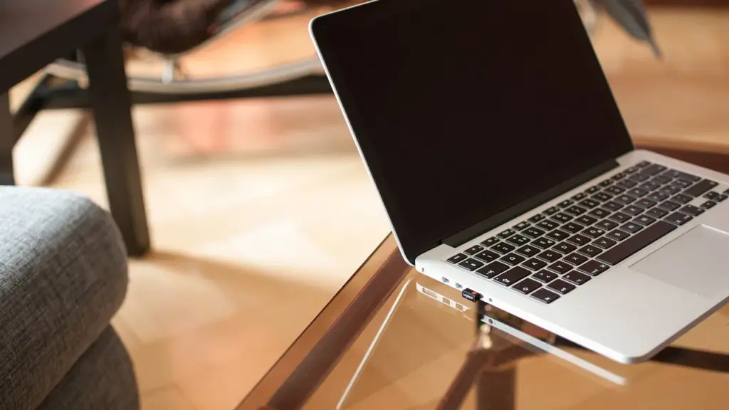 Slim laptop on a desk showing a keyboard and trackpad