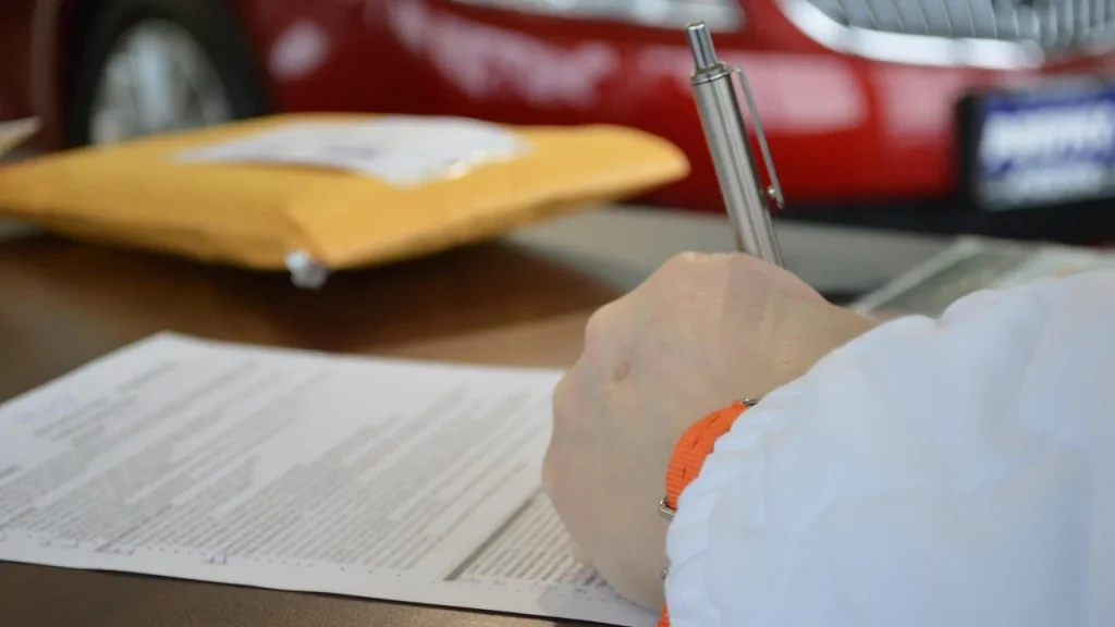 People signing financing or leasing paperwork