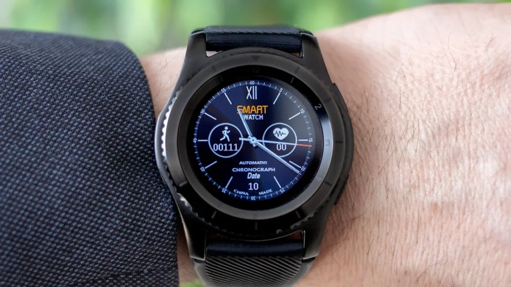 Close-up of a rugged smartwatch on a wrist in outdoor setting.