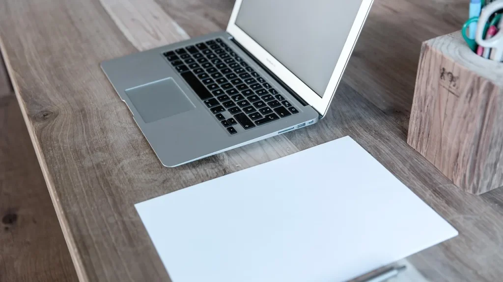 Desk with documents and laptop suggesting a tech insider’s story