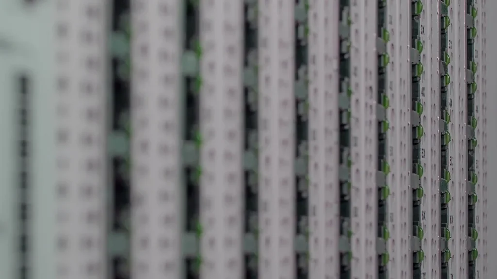 A data center server room with rows of racks and cables