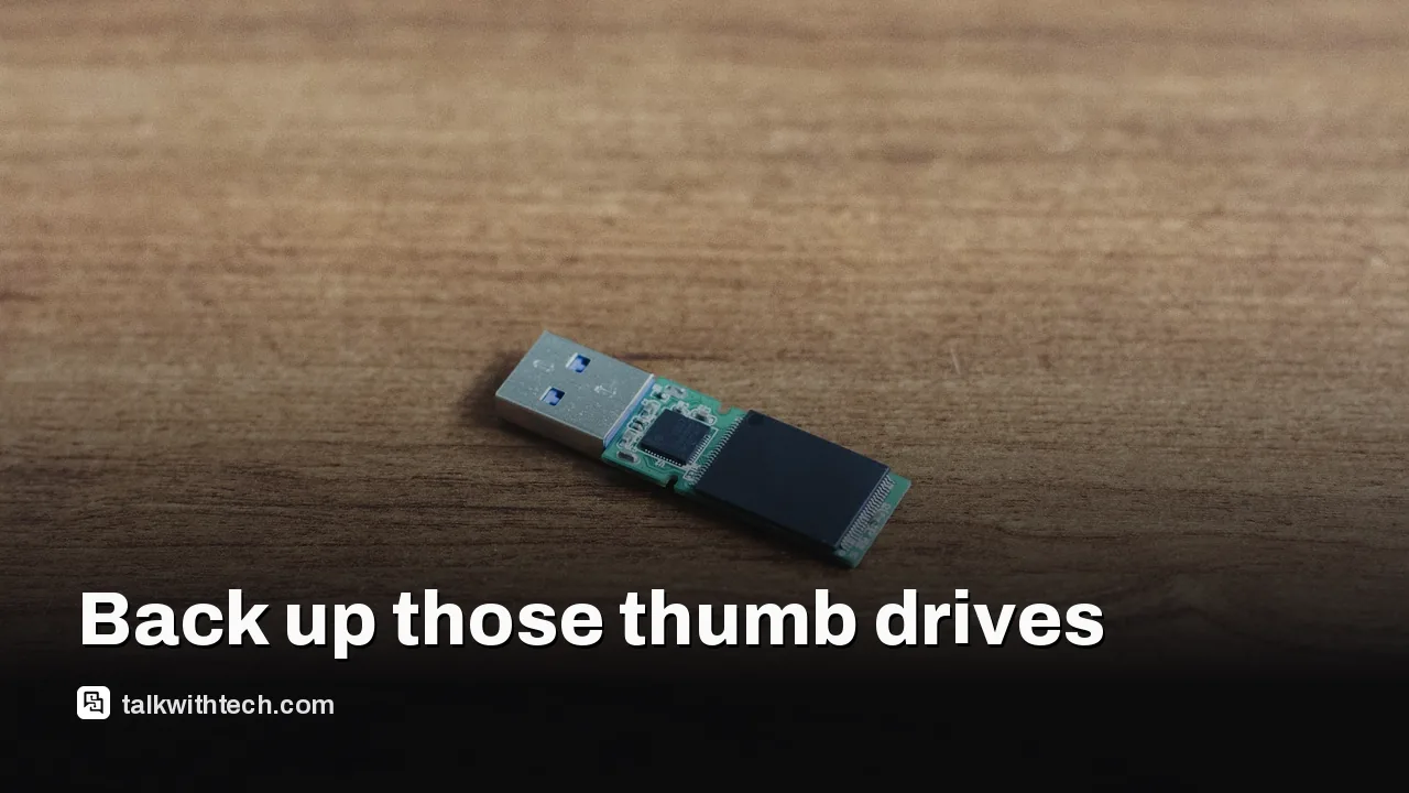 A small USB thumb drive on a desk with papers nearby
