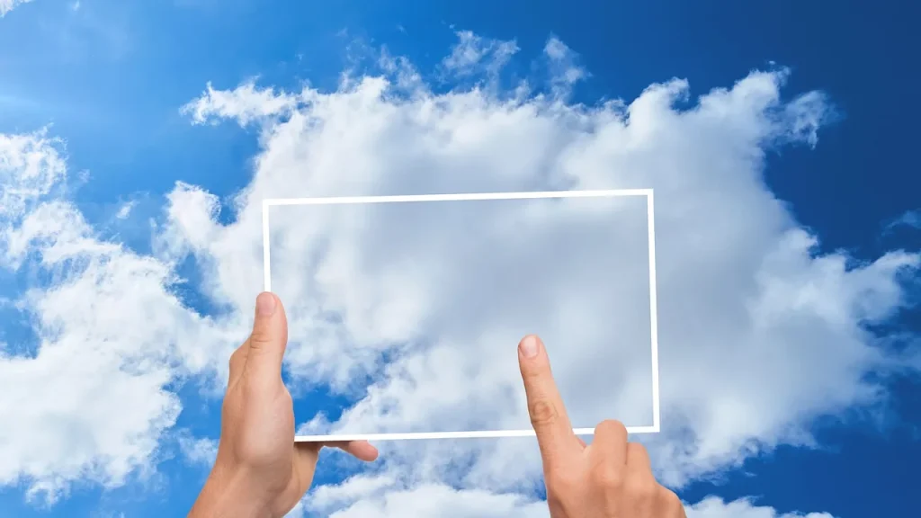 A hand holding a device with a cloud storage icon