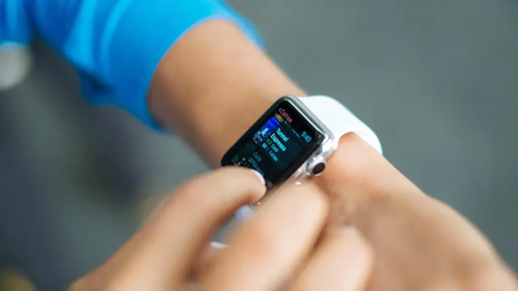 Person wearing a small AI wearable on the wrist