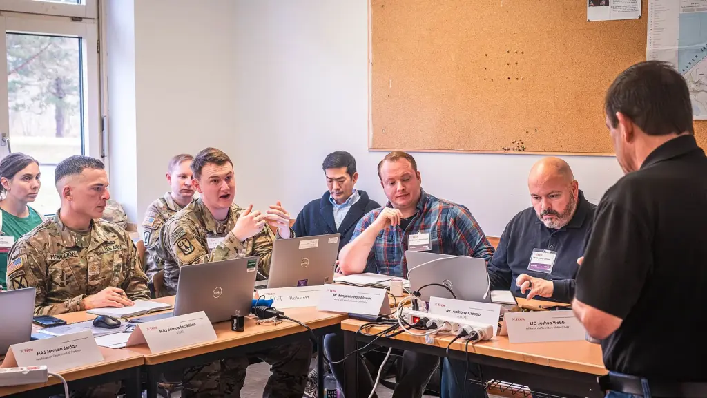 People in a meeting with charts and documents on a conference table