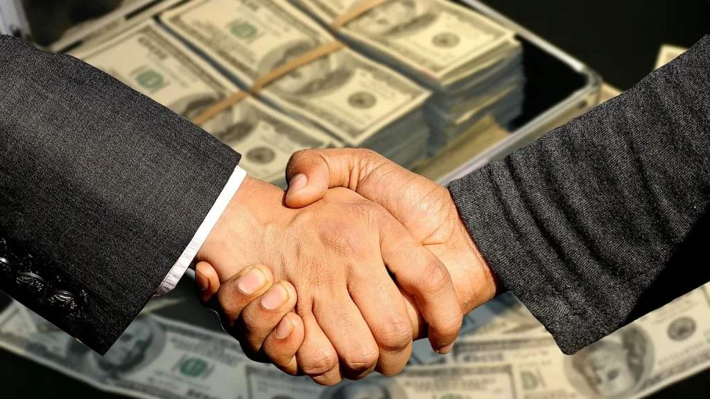 Two hands shaking over a private equity deal