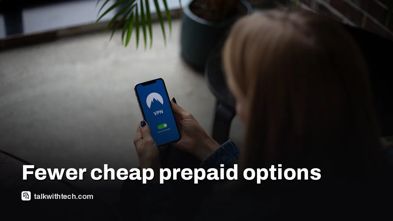 A person holding a smartphone with a prepaid plan ad in the background