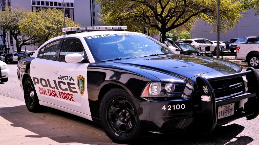 Police cars driving by at night in an urban area