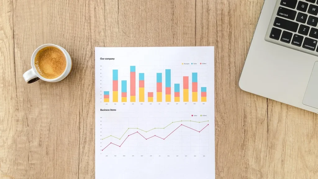Team meeting with charts and a laptop illustrating data insights
