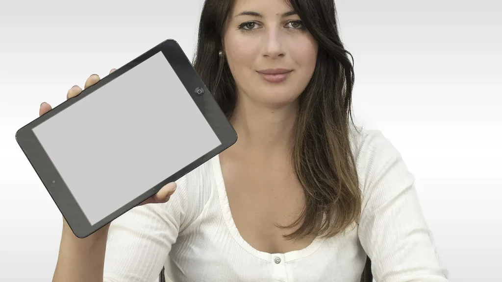 Person using a laptop and tablet to run AI models