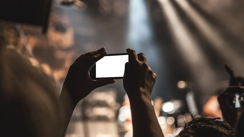 Close-up of a smartphone in a hand showing a home screen