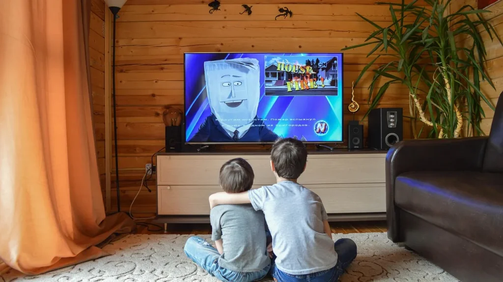 Family gathered around a screen in a cozy living room