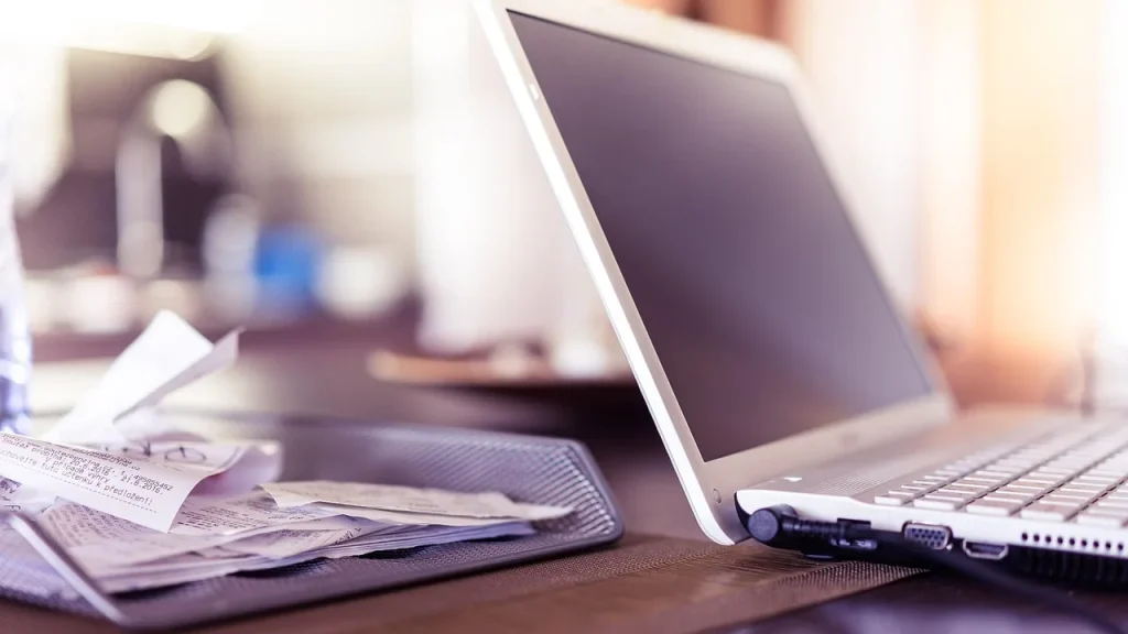 Laptop with a purchase receipt on a desk