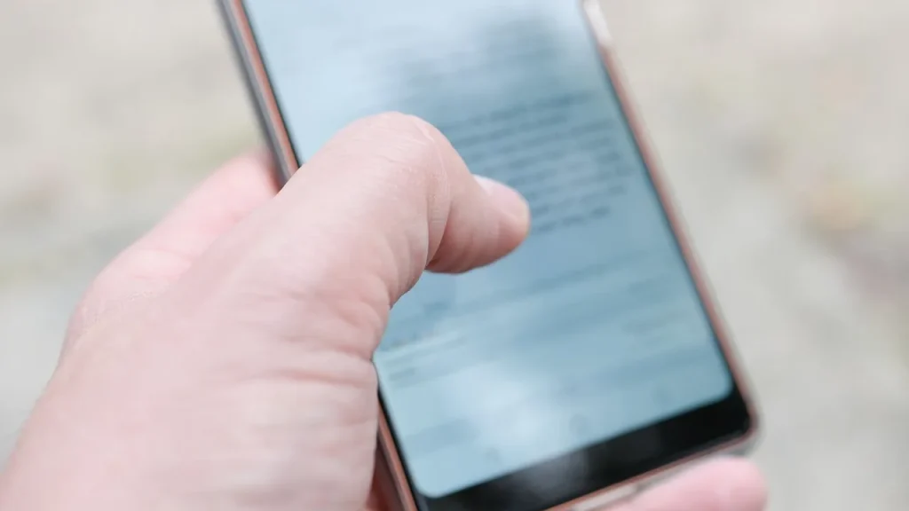 Person tapping a three-dot menu on a post