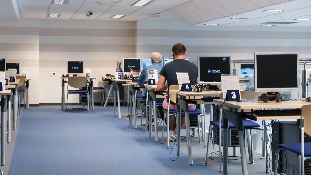 Public library seating with computers and shelves in the background