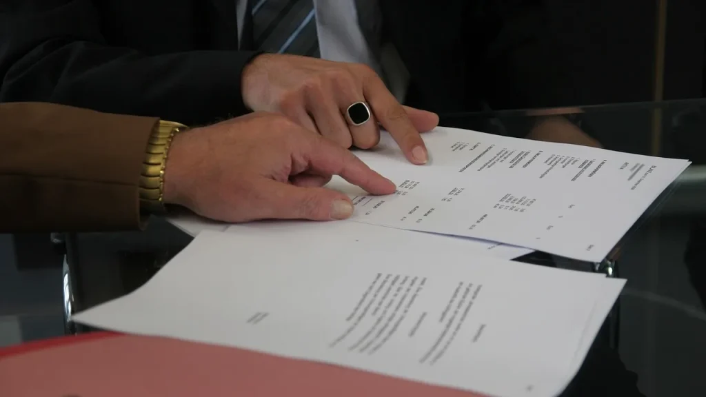 Officials in a meeting discussing contracts and funding