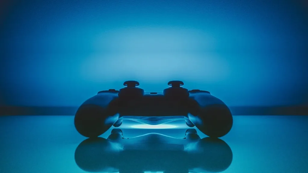 Close-up of a game controller and a PS5 case on a table