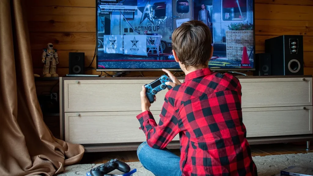 A modern game console on a TV stand in a living room