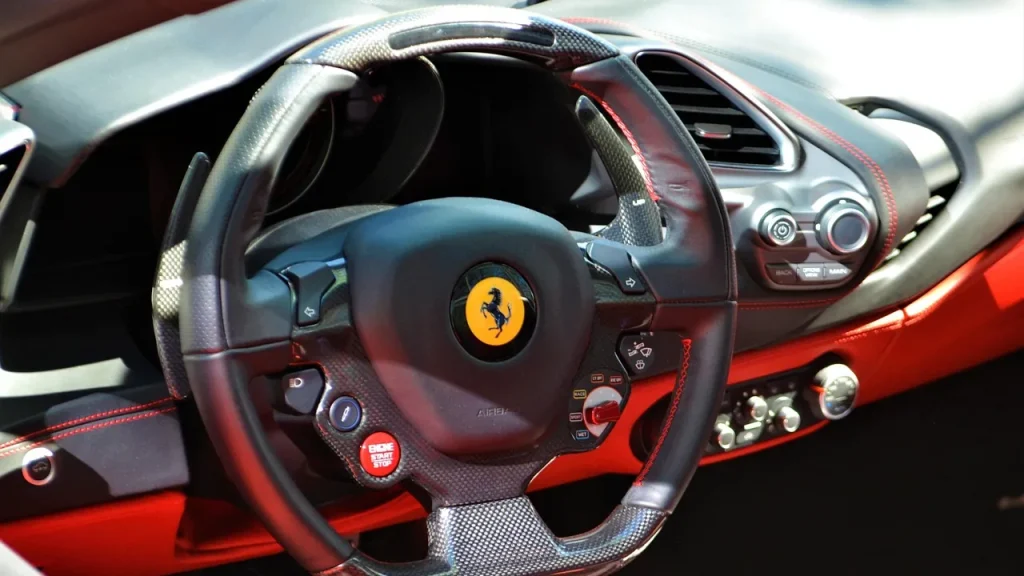Close-up of a racing game cockpit with steering wheel and pedals