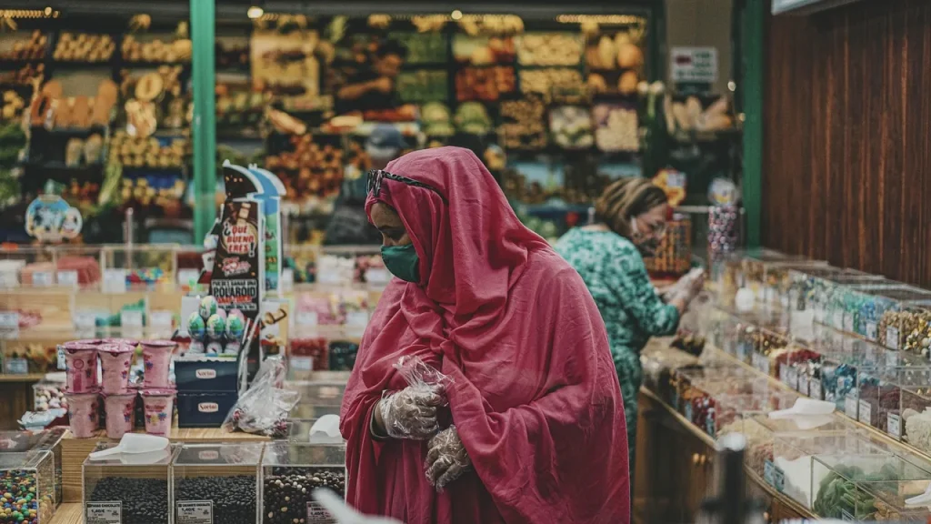 Shoppers compare smartphones in a brightly lit store.
