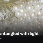 Glass bead entangles with light in a step toward quantum memory