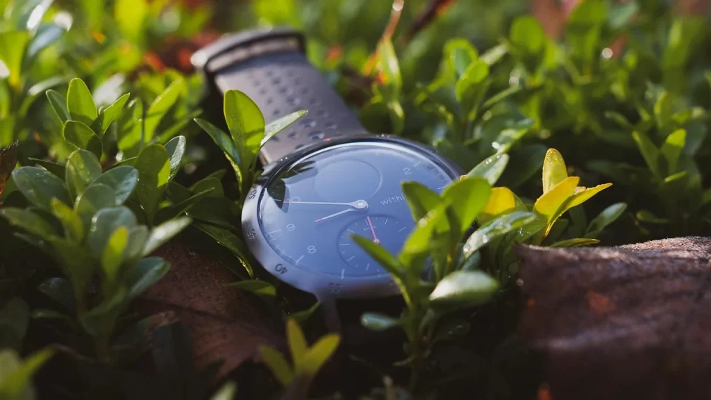 A wrist with fitness tracking sensors visible