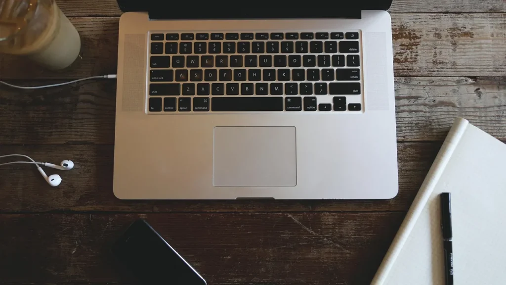 A desk setup with coffee, notebook, and a plan outline