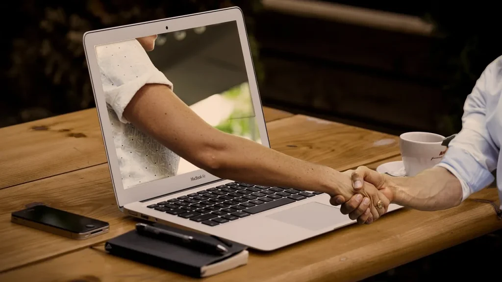 People discussing on a laptop with charts
