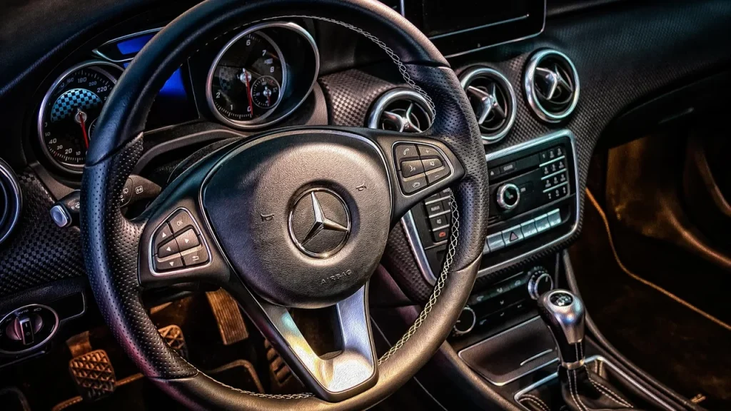 Car dashboard screen showing app icons in a modern infotainment system