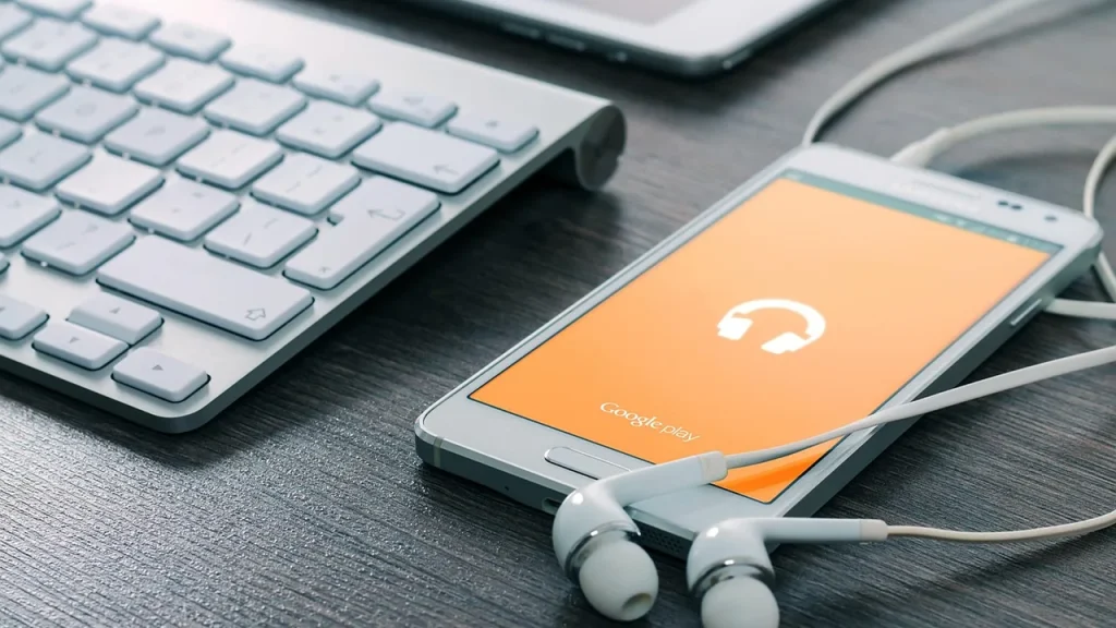 A phone connected to a desktop setup showing cross-device syncing