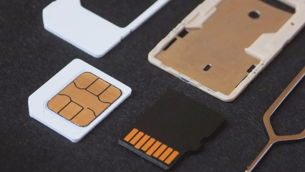 Phone showing SIM tray and network icons on screen
