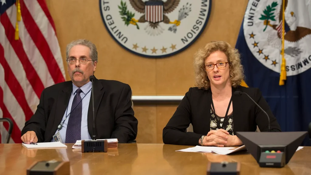 Officials in a regulatory meeting discussing telecom policy
