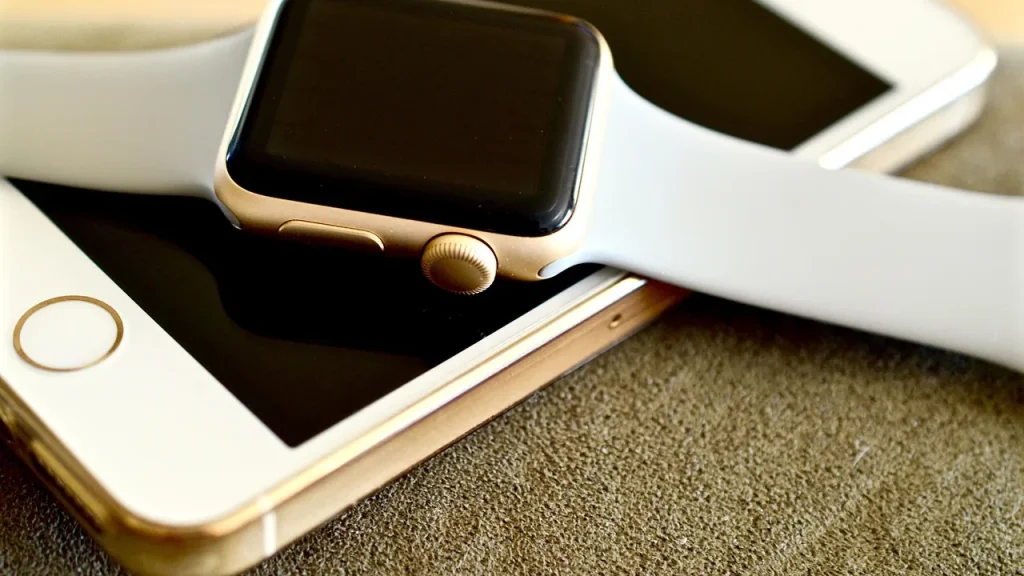 Child with a smartwatch and phone at a dining table