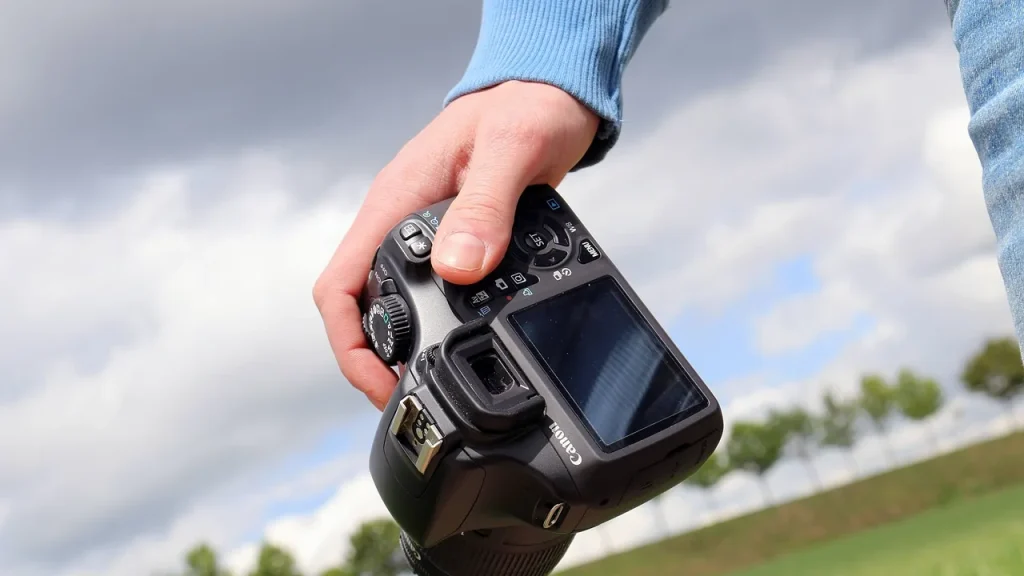 Hand holding a large phone showing its rear camera bump
