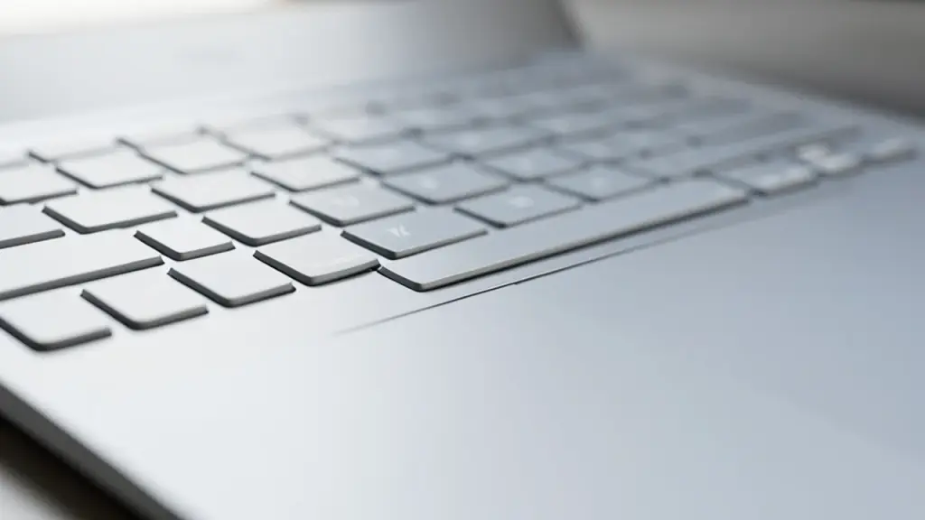 Close view of a pale grey laptop keyboard and touchpad