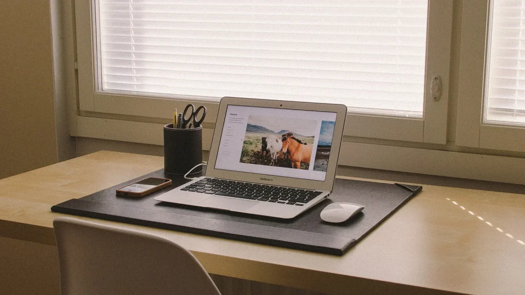 A modern smartphone on a desk with app icons visible