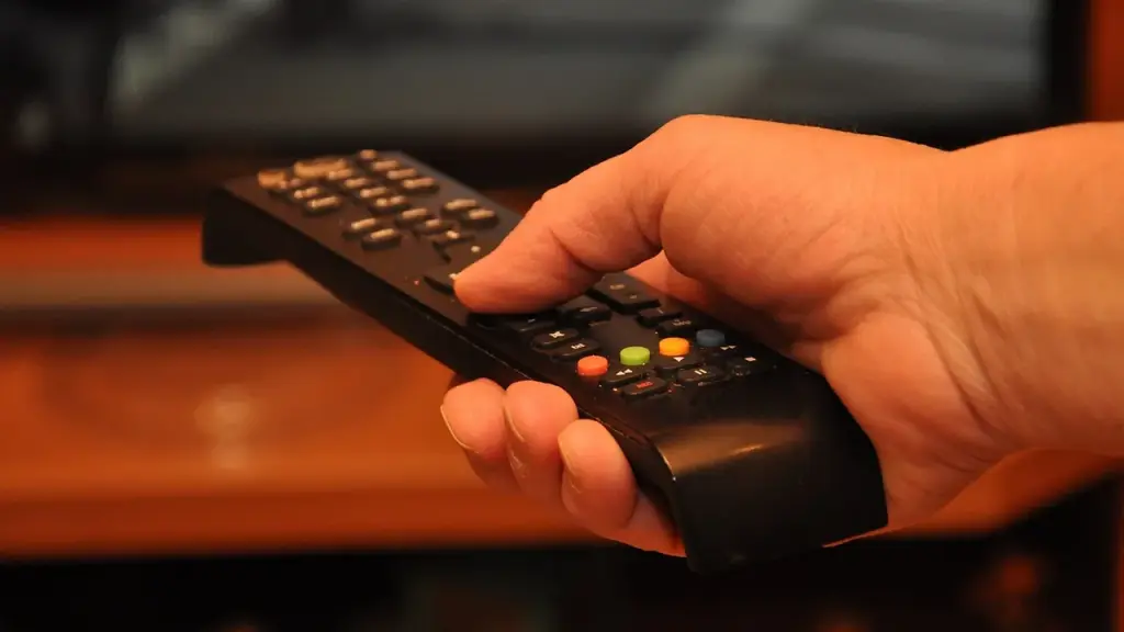 Person using a remote to watch TV in a living room